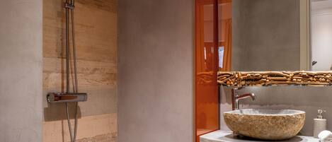 Un baño moderno con ducha, inodoro y lavamanos.