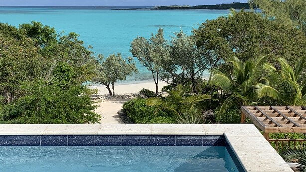 A pool with a view of a beach and ocean. - Paradise! Private Beachfront Home w/ Pool & Beach WiFi!  

 (George Town)