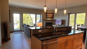 A modern kitchen with a large island, stainless steel appliances, and pendant lighting. - CLEAN-MODERN-WIFI-HARBOUR & MTN VIEWS-SPACIOUS-SHORT WALK TO TOWN & BEACH TRAILS (ucluelet)