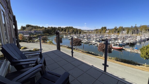 A balcony with a view of a marina and a lake. - CLEAN-MODERN-WIFI-HARBOUR & MTN VIEWS-SPACIOUS-SHORT WALK TO TOWN & BEACH TRAILS (ucluelet)