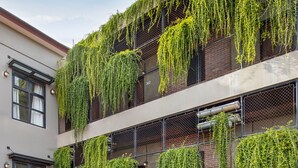 A multi-story building with extensive vertical gardens covering the balconies and windows. - The Aswana Seminyak (Seminyak)