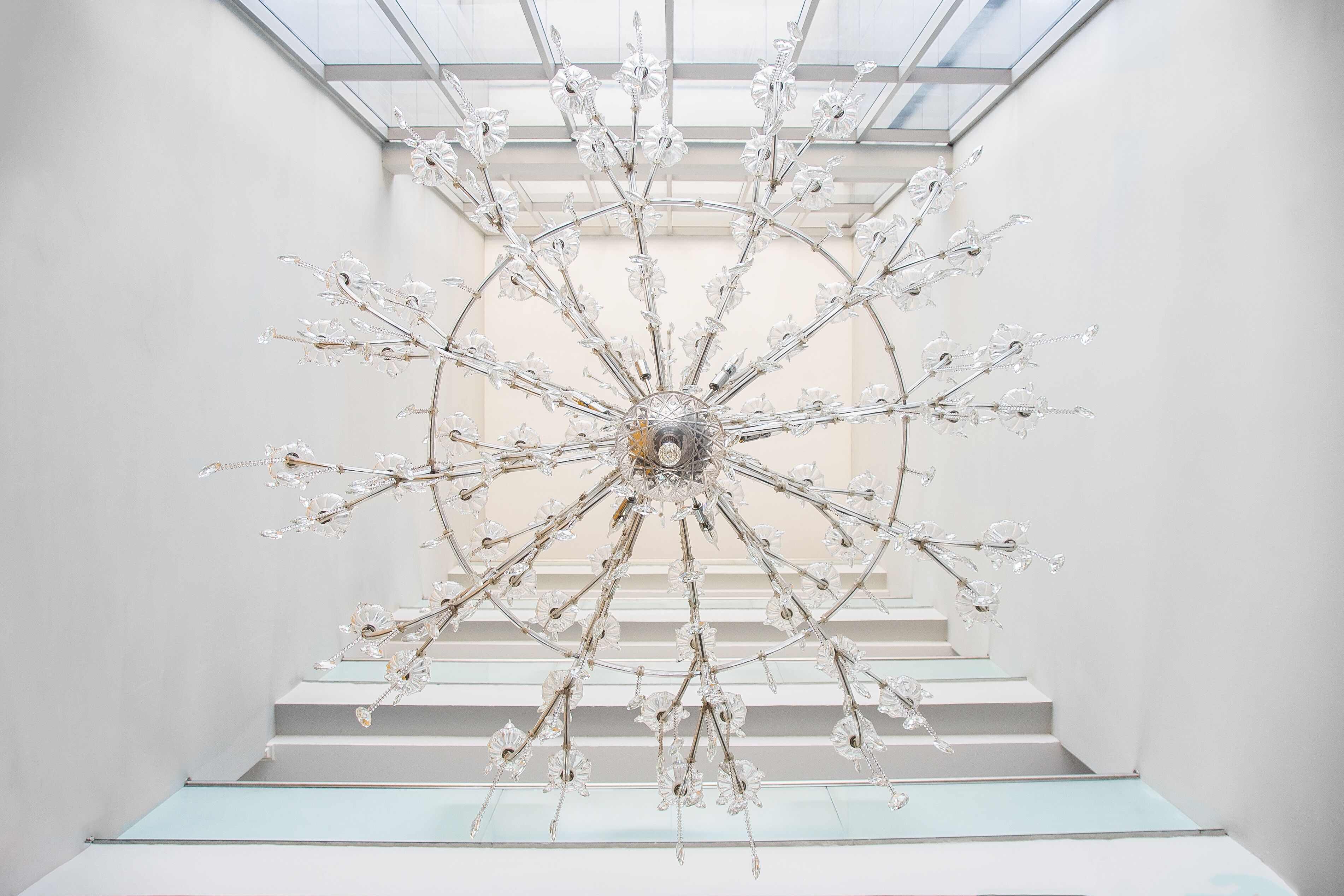 A modern interior with a unique chandelier design hanging from the ceiling.