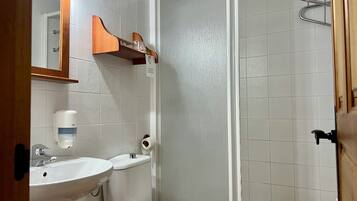 A bathroom with a sink, toilet, and shower.
