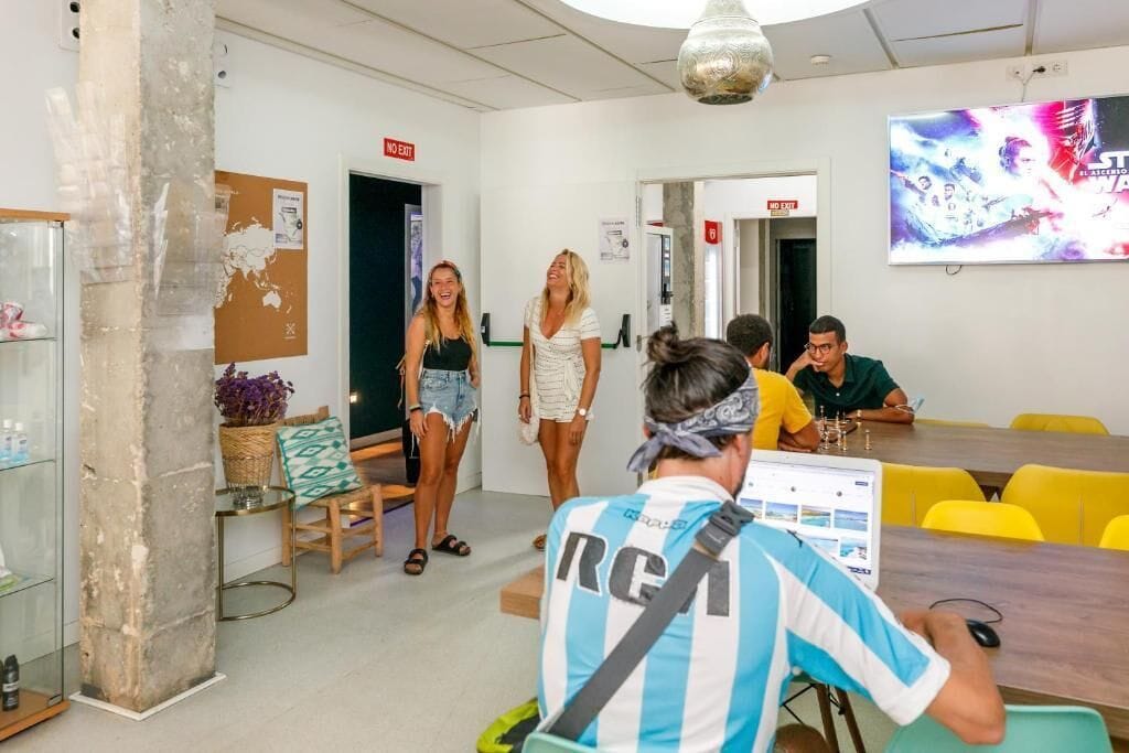 A modern meeting room with a glass partition, a map on the wall, and a TV screen displaying a movie.