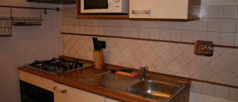 Apartment | Private kitchen | Coffee/tea maker, full-size fridge, microwave, oven