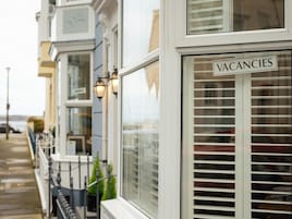 A row of townhouses with a 'VACANCIES' sign on the right.