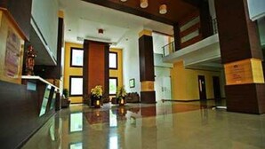 A spacious lobby with a polished floor, a reception desk, and a staircase leading to an upper level. - Sterling V Grand Madurai (Madurai)