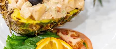 A salad with shrimp, olives, and a creamy dressing on a bed of lettuce.