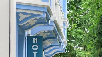 A hotel sign with 'HOTEL' and 'BELLE EPOQUE' on a building facade.