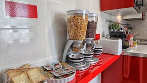 A breakfast buffet with cereal, bread, and spreads. - City Central (Salerno)