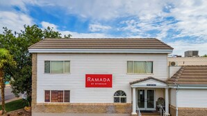 A two-story building with a sign reading "RAMADA BY WYNDHAM".
