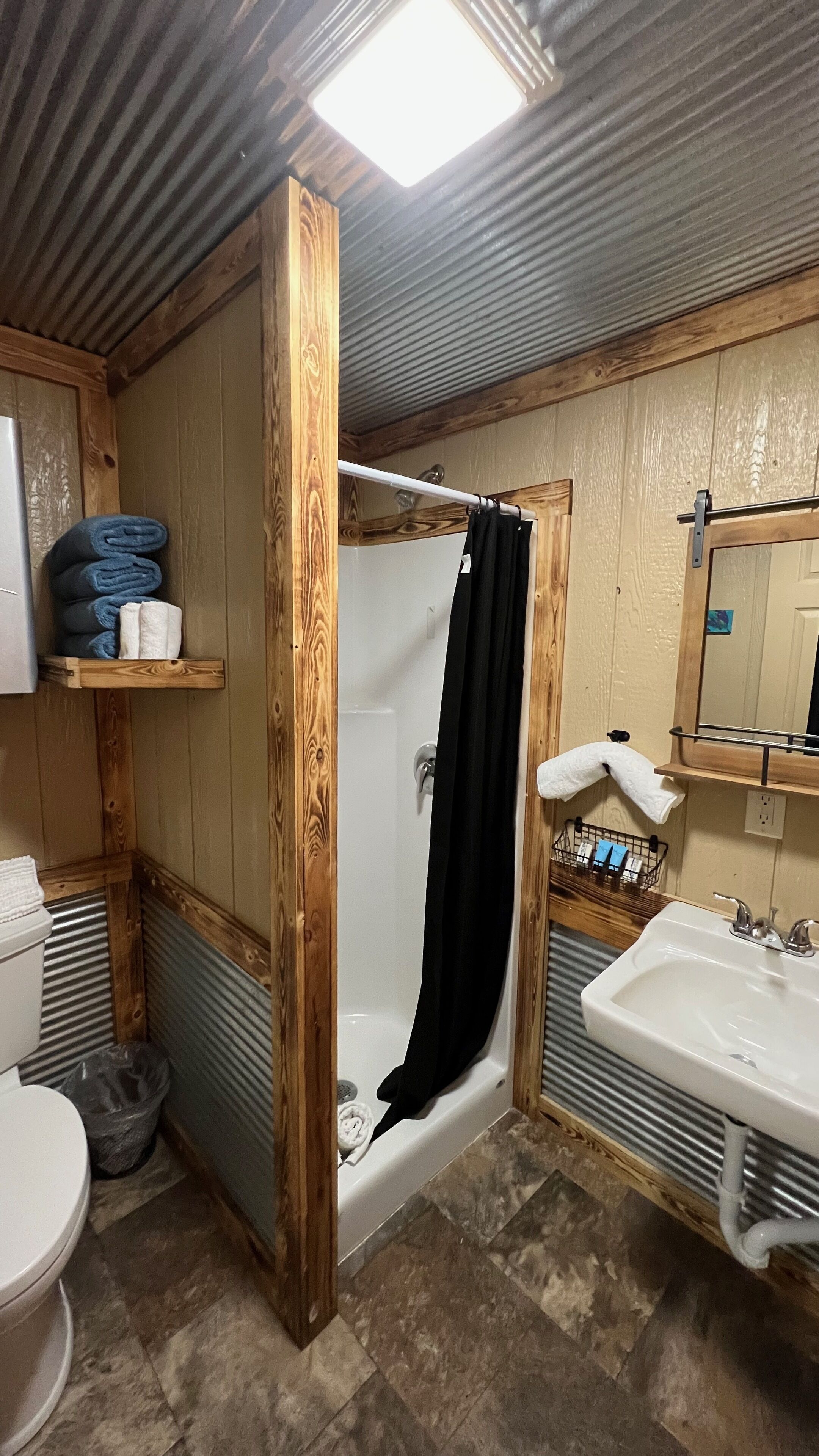 A bathroom with a bathtub, a sink, a toilet, and a shower curtain.