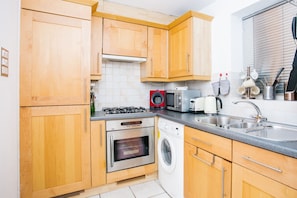 Enjoy cooking in this well-equipped kitchen with a gas stove, oven, microwave, and dishwasher.
