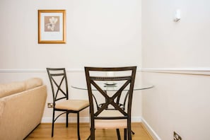 Relax in this stylish room with a round table, two classic chairs, and a comfortable sofa.