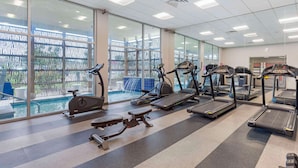 A gym with treadmills, elliptical machines, and a rowing machine. - GLō Best Western Dallas South DeSoto (DeSoto)