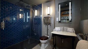 A modern bathroom with a shower, toilet, and sink.