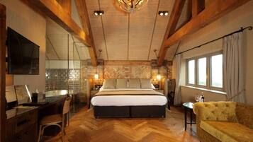 Relax in this serene bedroom with a large bed, nightstands, and a mounted TV.