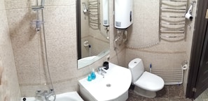 A bathroom with a shower, toilet, sink, and towel rack. - Hostel Voyage (Kyiv)