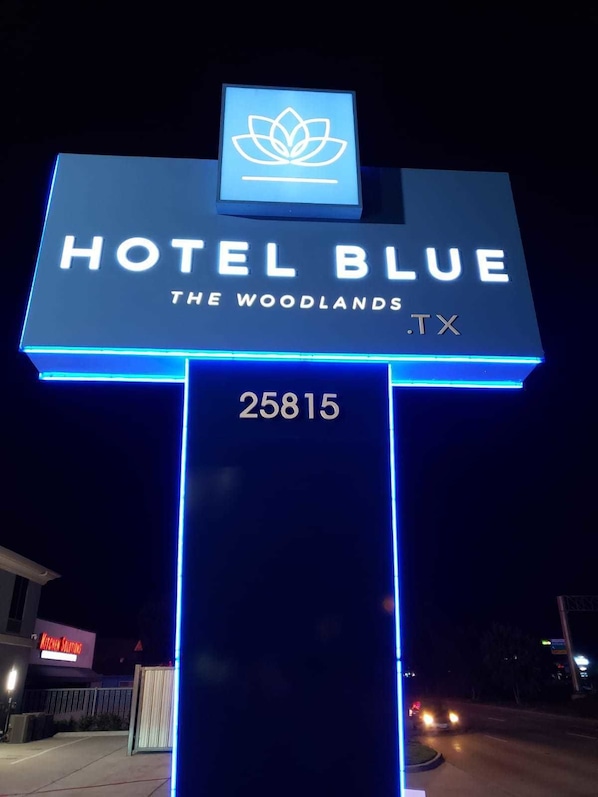 Welcome to Hotel Blue The Woodlands, TX, featuring a distinctive lotus flower logo.