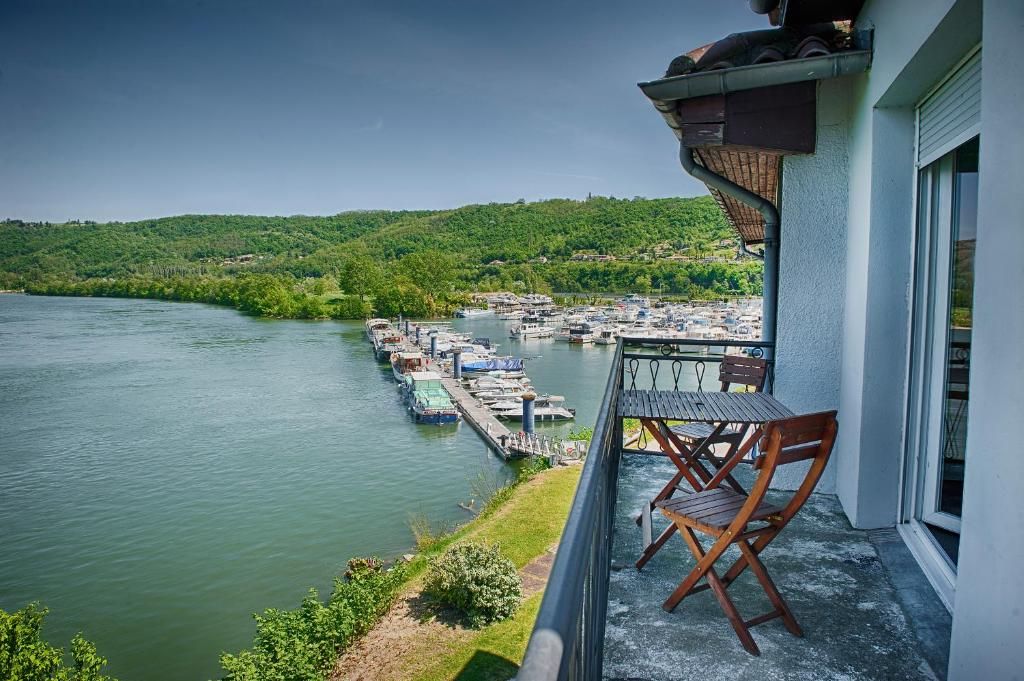A balcony with a view of a marina and a river.