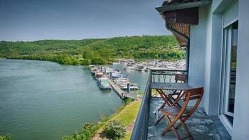 A balcony with a view of a marina and a river.