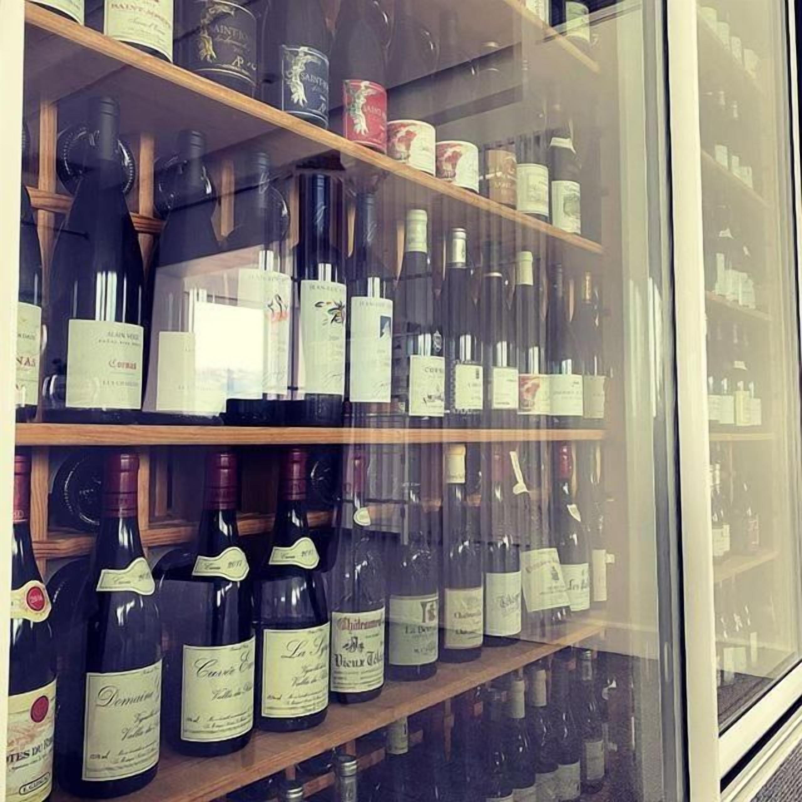 A wine rack with various bottles of wine.