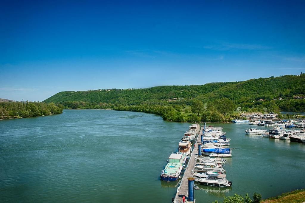 A river with a dock and boats.