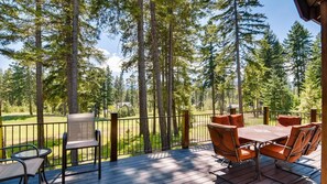 A deck with outdoor furniture overlooking a forested area. - Elk Run Lodge (Cle Elum)