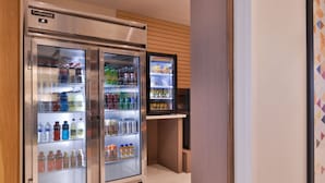 A refrigerated display case with various beverages and a digital clock. - Holiday Inn Express & Suites Marshalltown by IHG (Marshalltown)