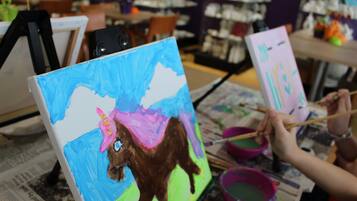 A painting of a unicorn on a canvas.