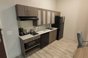 A compact kitchen with a dishwasher, stove, oven, and refrigerator.