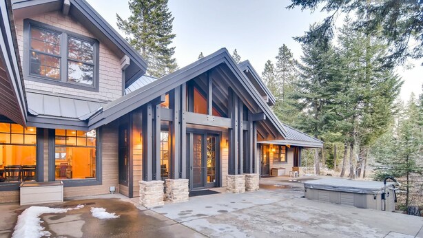 A modern house with a large front porch, stone pillars, and a covered patio area. - Pine Ridge Estate (Cle Elum)