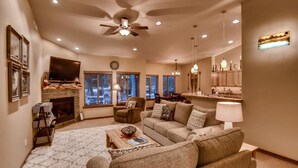 A cozy living room with a fireplace, comfortable seating, and a television. - Ridgeview Lodge (Cle Elum)