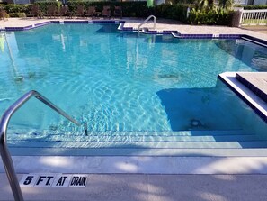 A swimming pool with clear blue water, marked depth lines, and a 5 ft. drain line. - Condo near IMG Academy & Beaches (Bradenton)