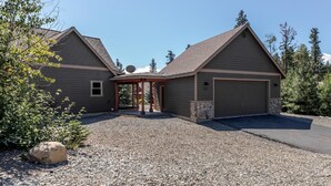A two-story house with a covered entryway and a garage.