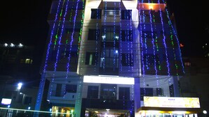 A building with multiple floors, featuring a series of vertical light strings. - Uni Resort (Cox's Bazar)