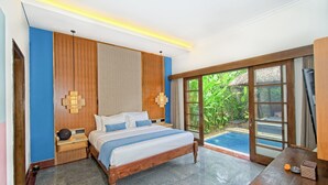 A bedroom with a bed, wooden headboard, bedside tables, and a view of a swimming pool. - Kecapi Villa Seminyak (Seminyak)