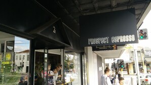 A storefront with a sign reading "PROSPECT ESPRESSO" and a website address "brasilianbutterfly.com". - Camberwell Holiday Apartment (Camberwell)