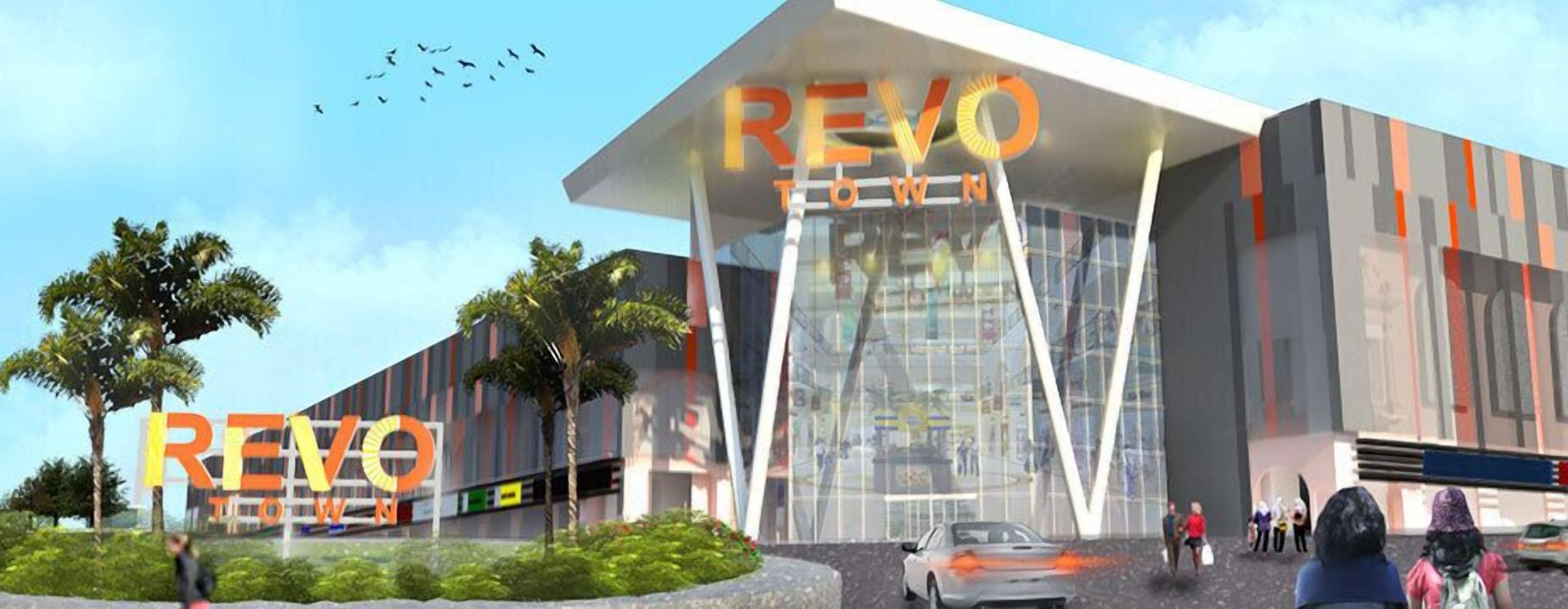 A modern building with the sign "REVO TOWN" prominently displayed.