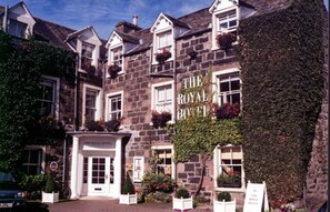 A traditional stone building with a sign reading "The Royal Hotel." - The Royal Hotel (Crieff)