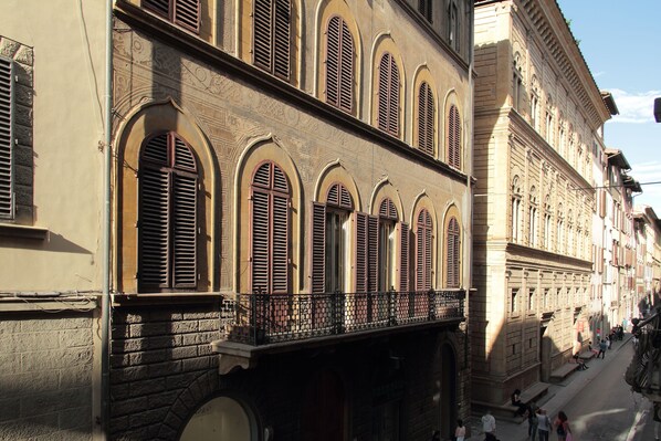 A historic building with arched windows and a balcony.