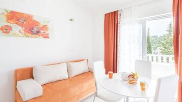 Apartment, 1 Bedroom, Sea View | Living area | Flat-screen TV