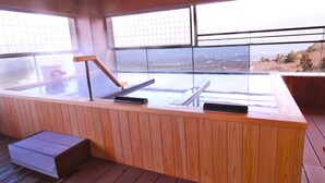 A wooden deck with a sauna area, large windows, and a view of the landscape. - ikaho shinki (Shibukawa)