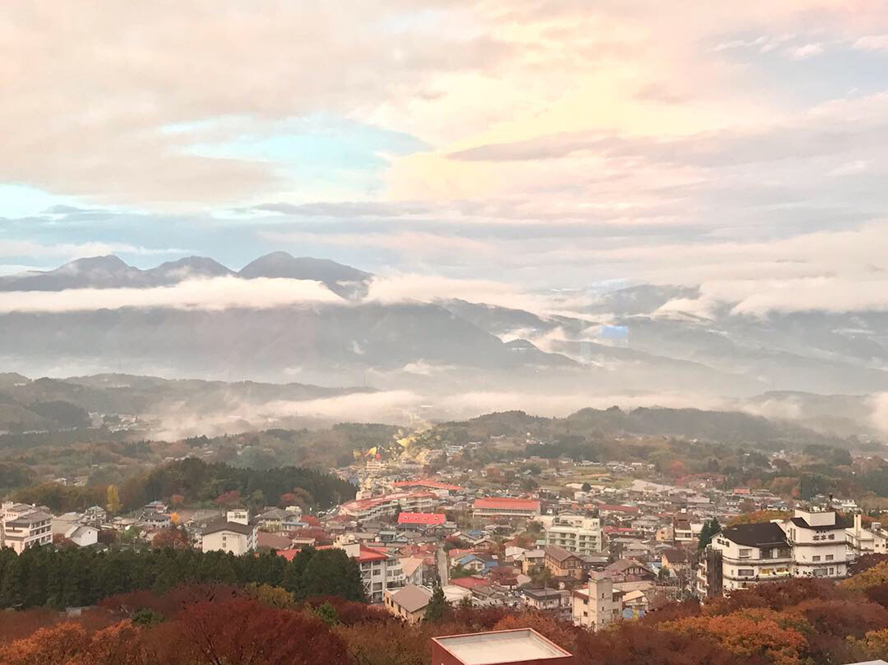 A town with buildings and mountains in the background.