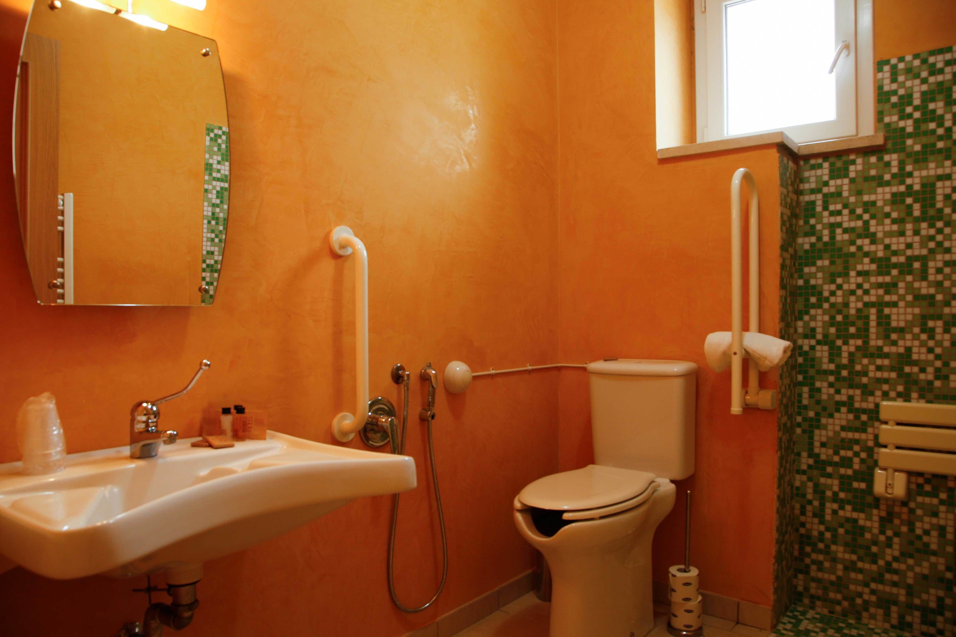 A bathroom with a sink, toilet, and shower.