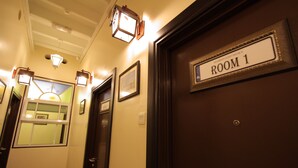 A hallway with a door labeled "ROOM 1" and a window with a view of a building. - Shamrock Guest House II (Ipoh)
