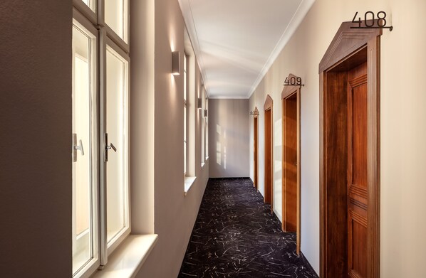A hallway with wooden doors numbered 408, 409, and 410.