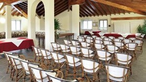 A spacious hall with rows of wicker chairs and a high wooden ceiling. - Hotel Villa Liberty (Pontecurone)