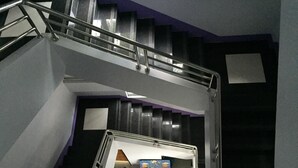 A staircase with metal railings leading to a landing area.