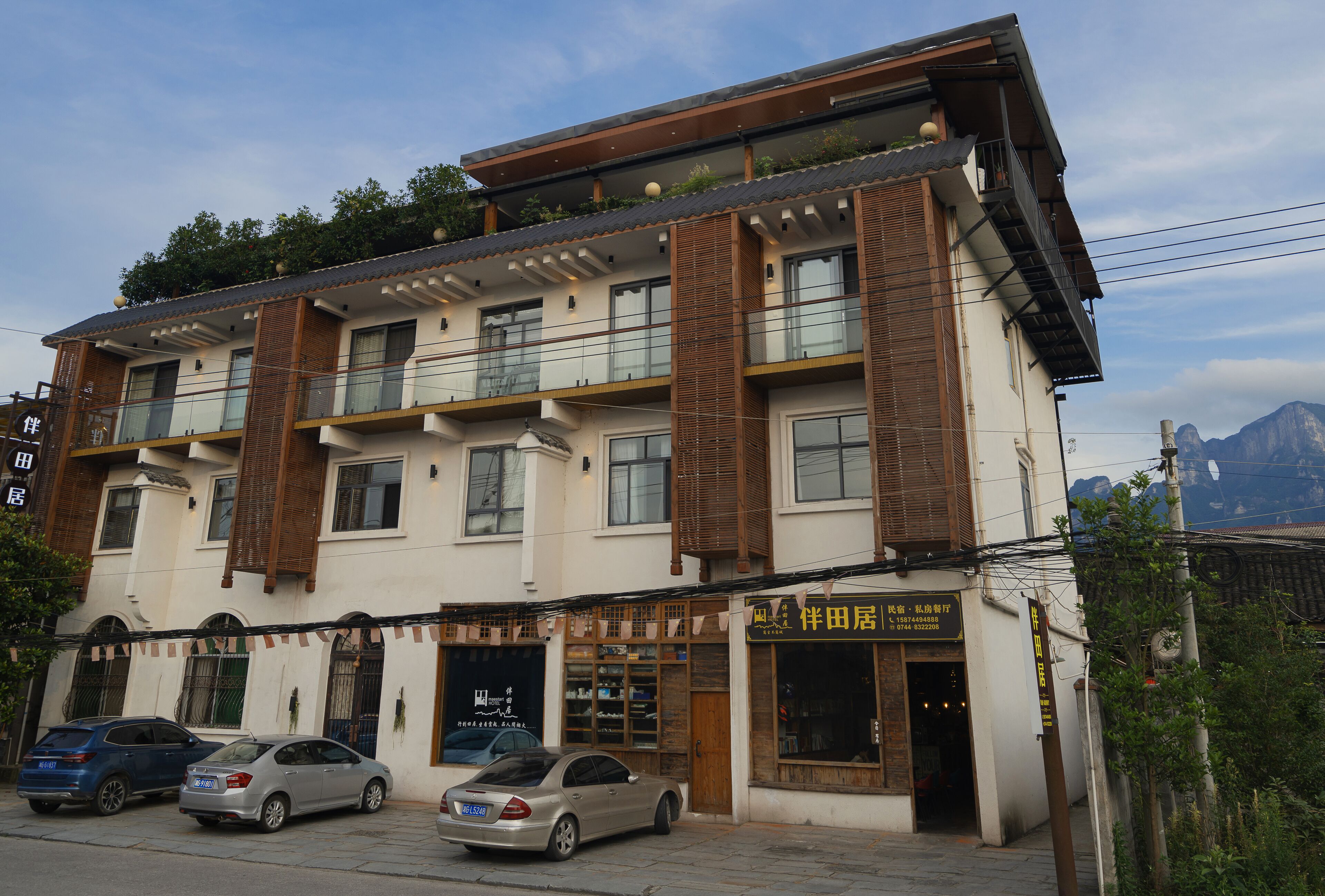 A multi-story building with a storefront on the ground floor, featuring a sign with Chinese characters.